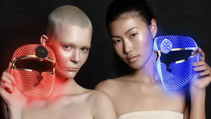 Two women with FAQ 202 plus LED light masks 
